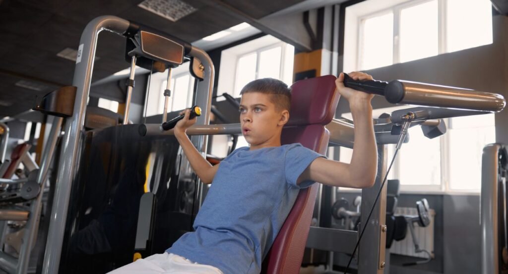 boy working out in gym independently