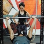 a man doing bench press using barbell press